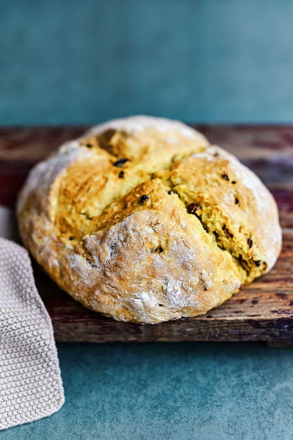 Irish soda bread with raisins on a rustic wooden board