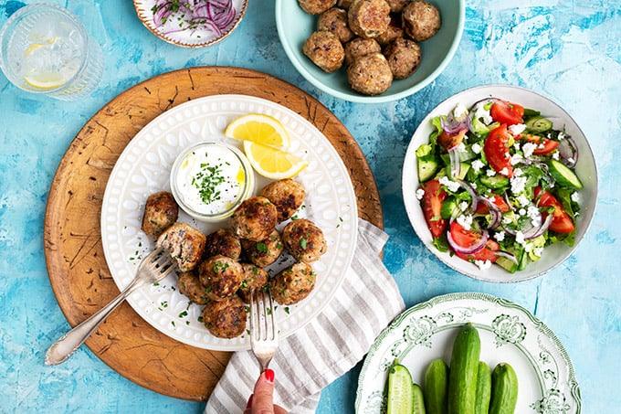 Healthy meatballs served with yoghurt dip and lemon wedges