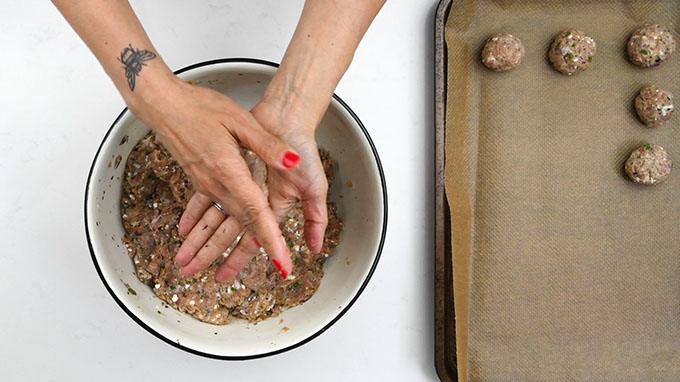 Rolling keftedes onto a tray