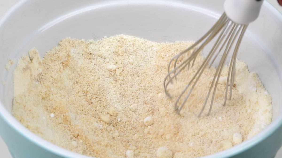 Stirring almond flour, coconut flour, sweetener and spices in a bowl