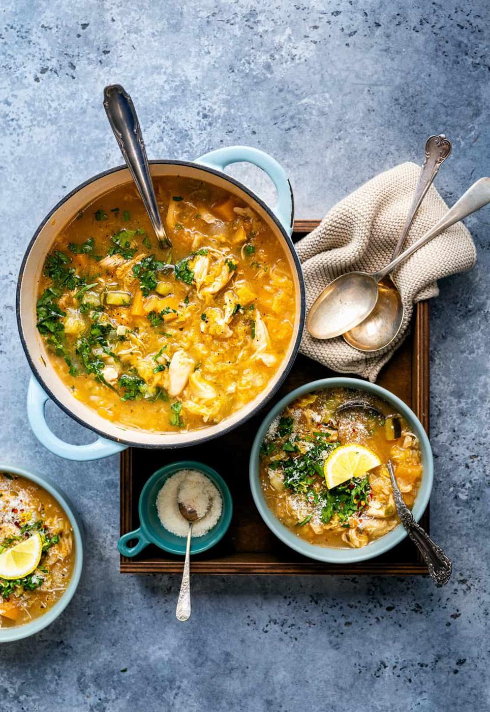 Pot of low carb chicken soup with bowls of soup on the side