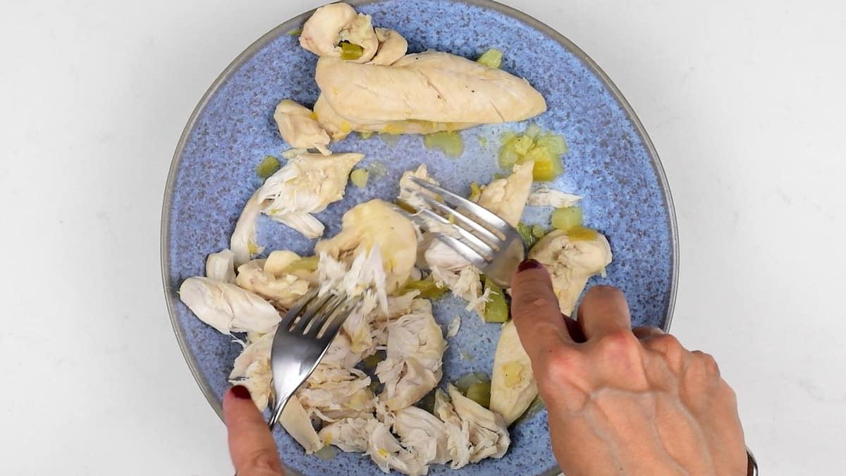 shredding chicken using two forks