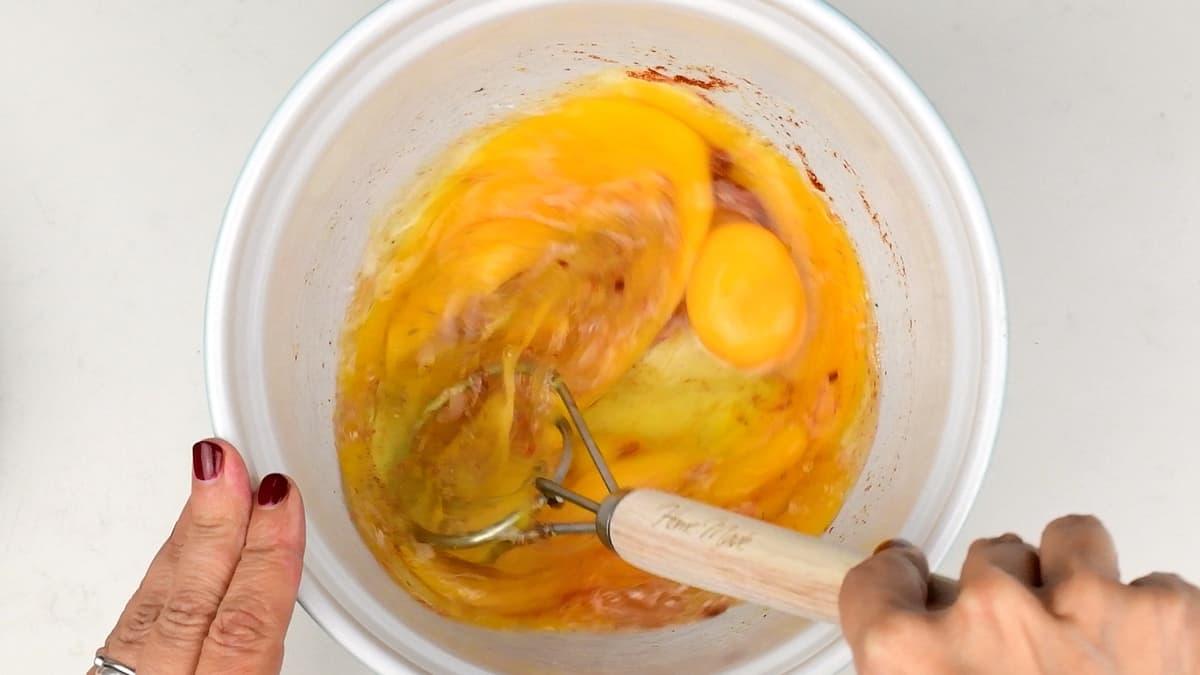 beating eggs and seasonings in a bowl