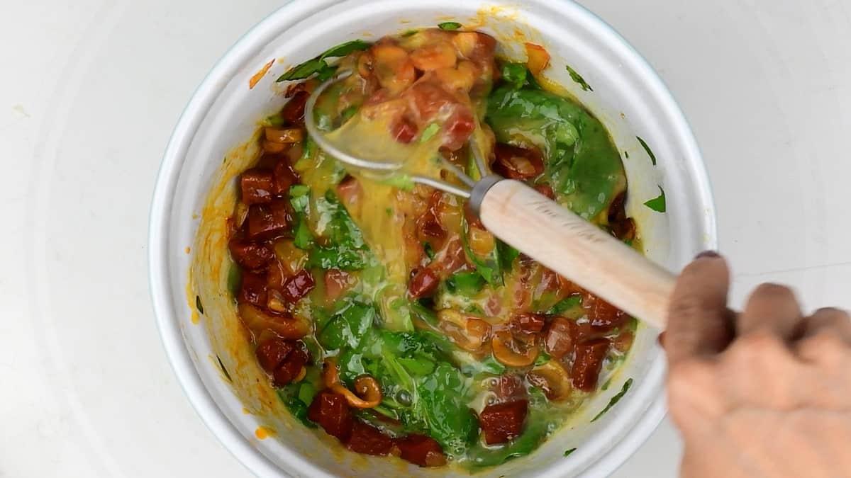 Mixing ingredients for keto frittata in bowl