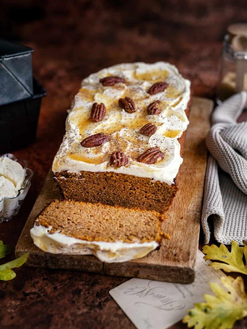 Low carb pumpkin bread with cream cheese frosting on a cutting board