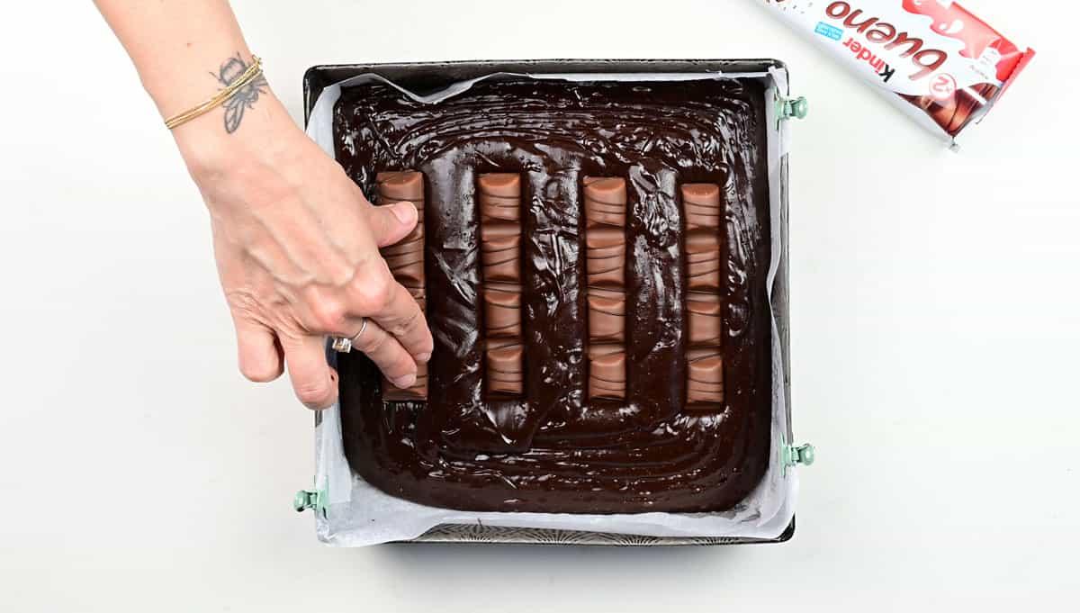 Pushing kinder bueno bars into brownie batter