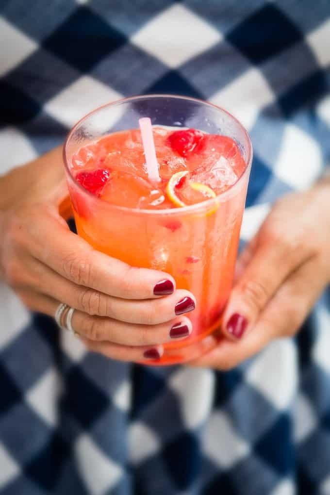 Woman holding a glass with rum cocktail