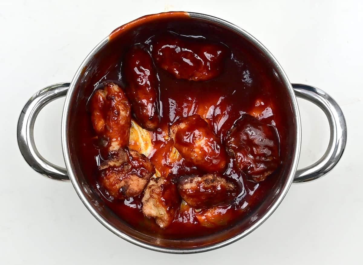 Tossing Korean Fried Chicken in sauce