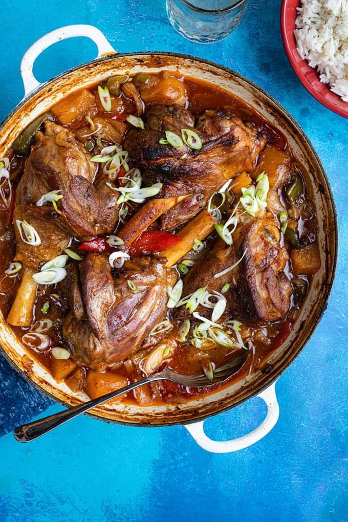 Braised lamb shanks in a cast iron casserole dish