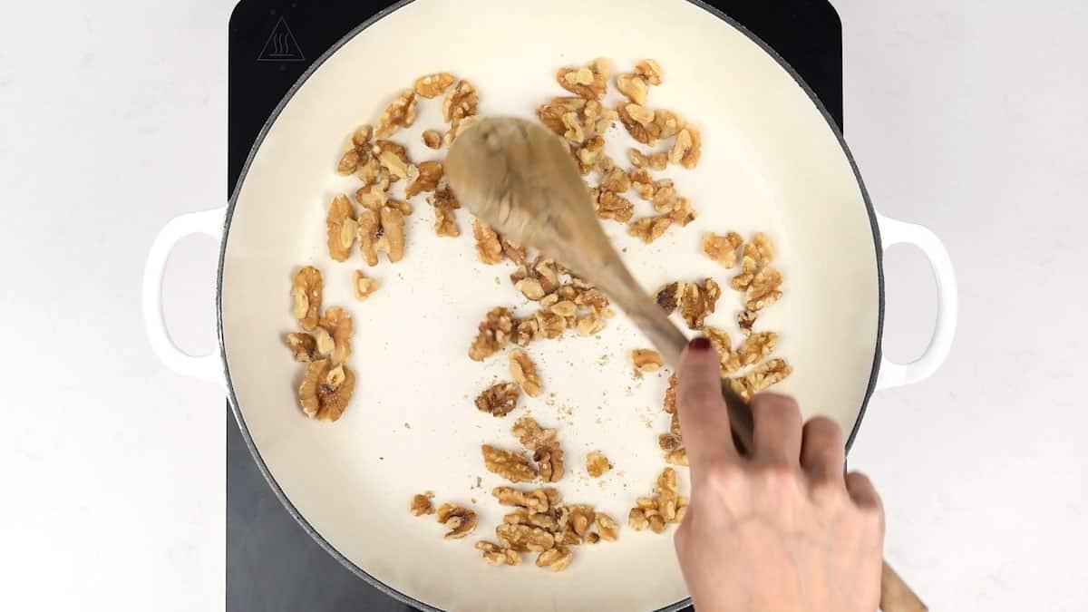 dry frying walnuts in a pan