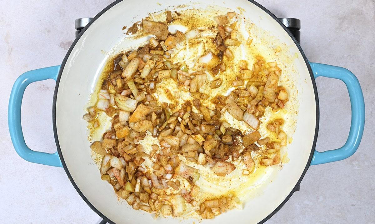 onions cooking in a skillet with spices