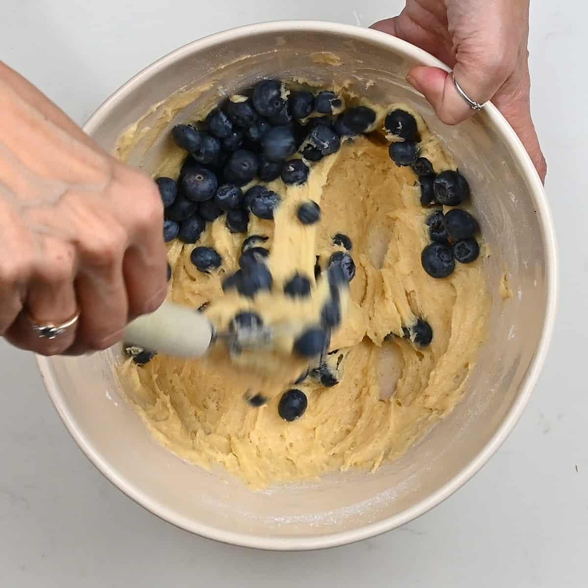 folding fresh blueberries into batter
