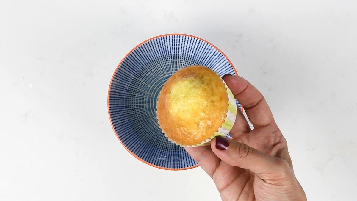 Dipping cupcakes into lemon syrup