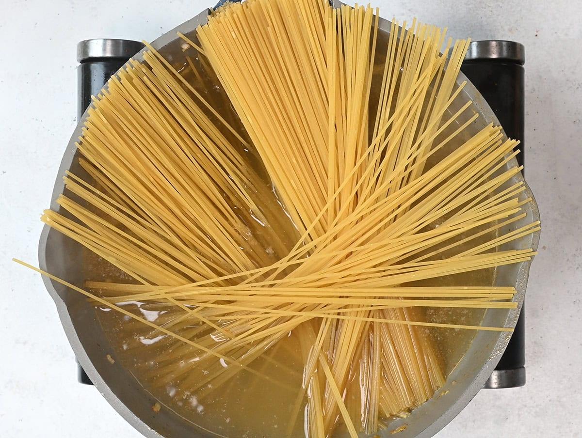 spaghetti cooking in a pan