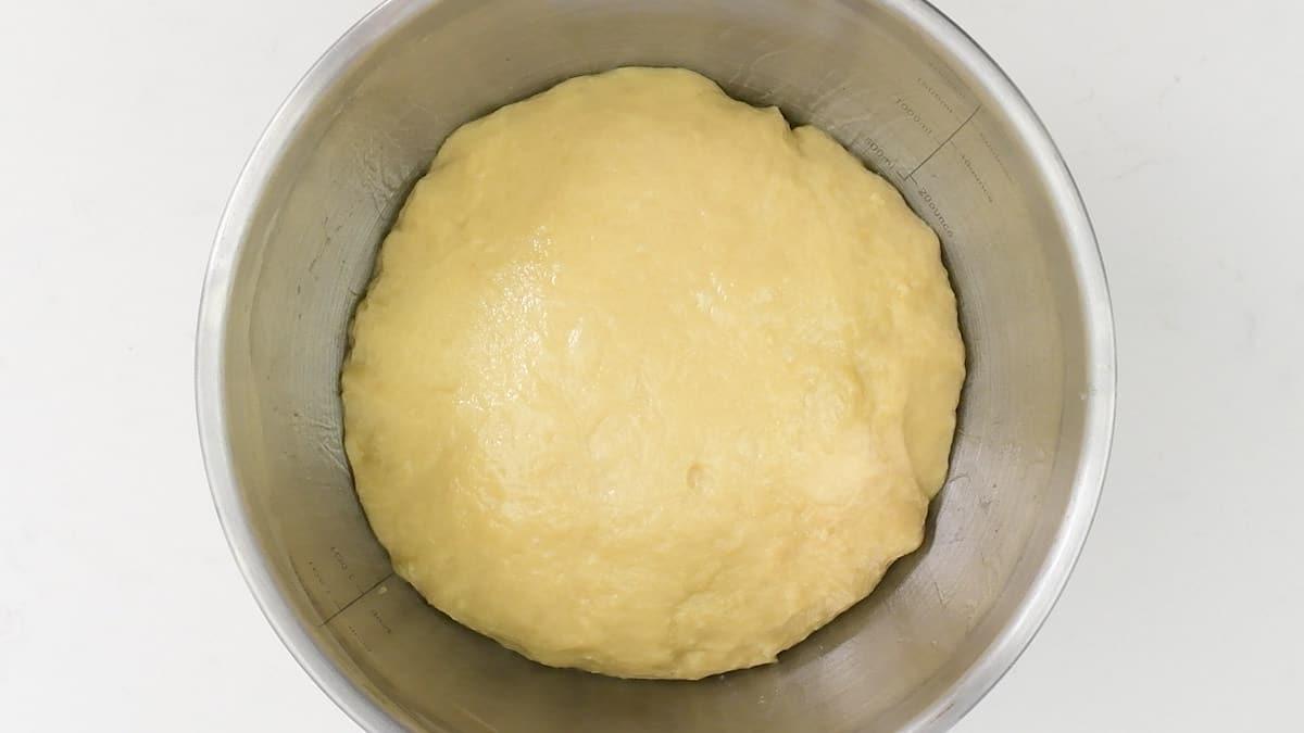 Brioche dough in a metal bowl