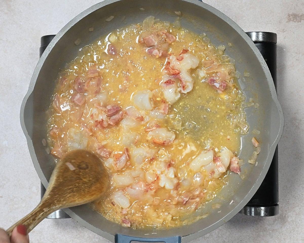 cooking shallots and lobster meat in a reduced wine sauce