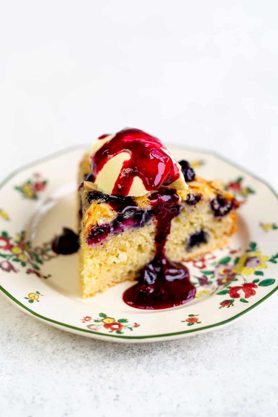 slice of low fat cake topped with ice cream and blueberry compote