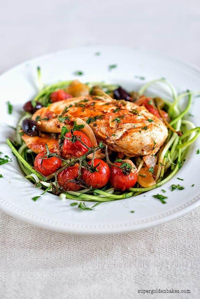 Chicken breast served with spiralled zucchini noodles and puttanesca sauce