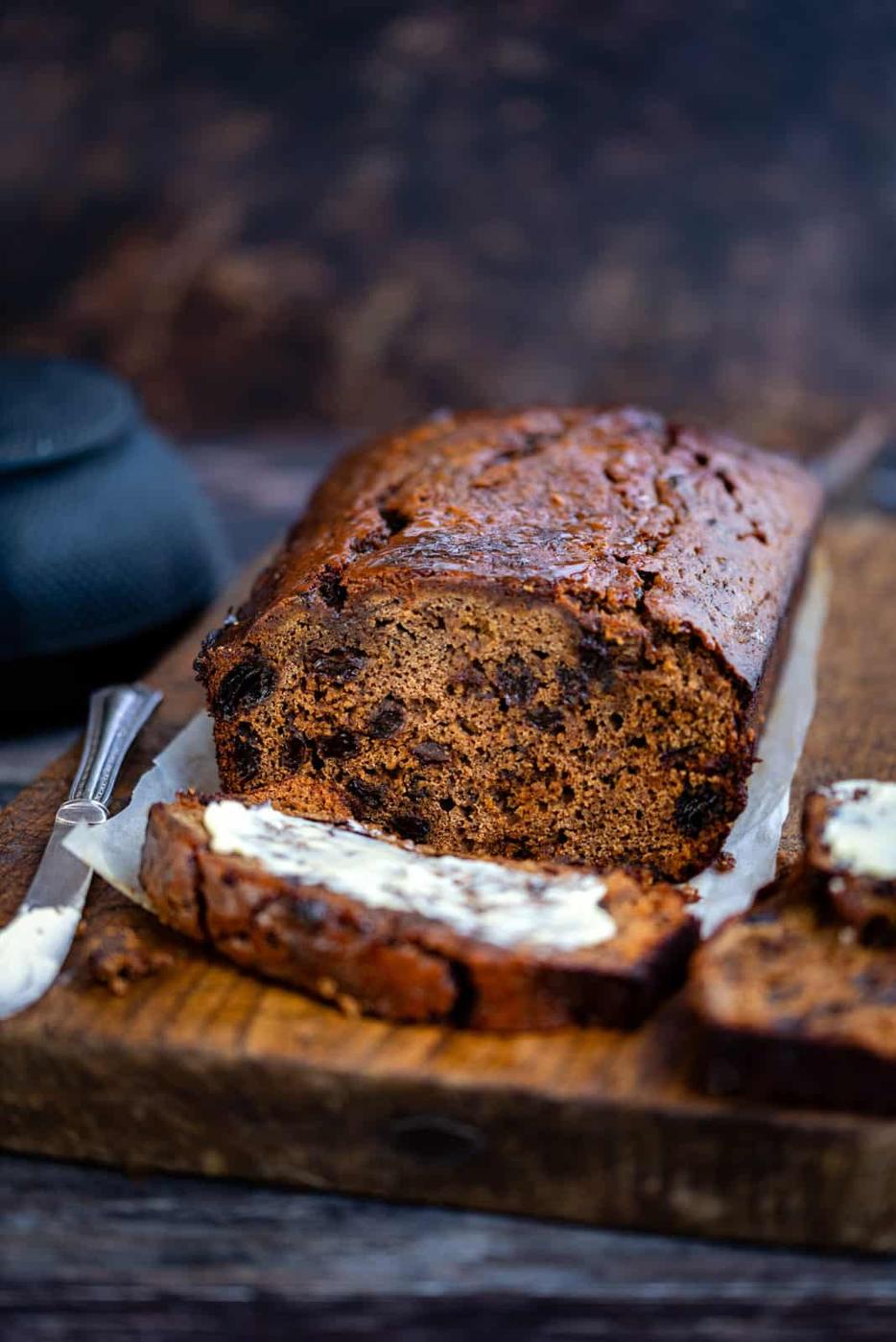 Sliced homemade malt loaf on a wooden cutting board