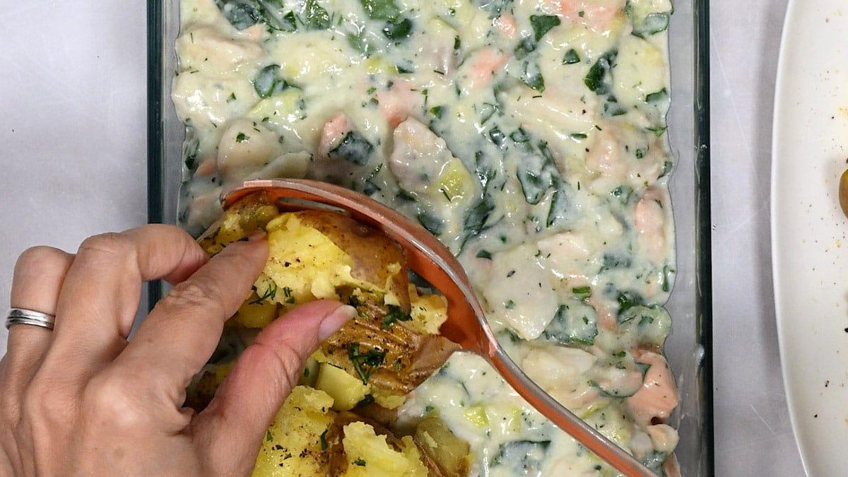 topping fish pie with crushed boiled potatoes