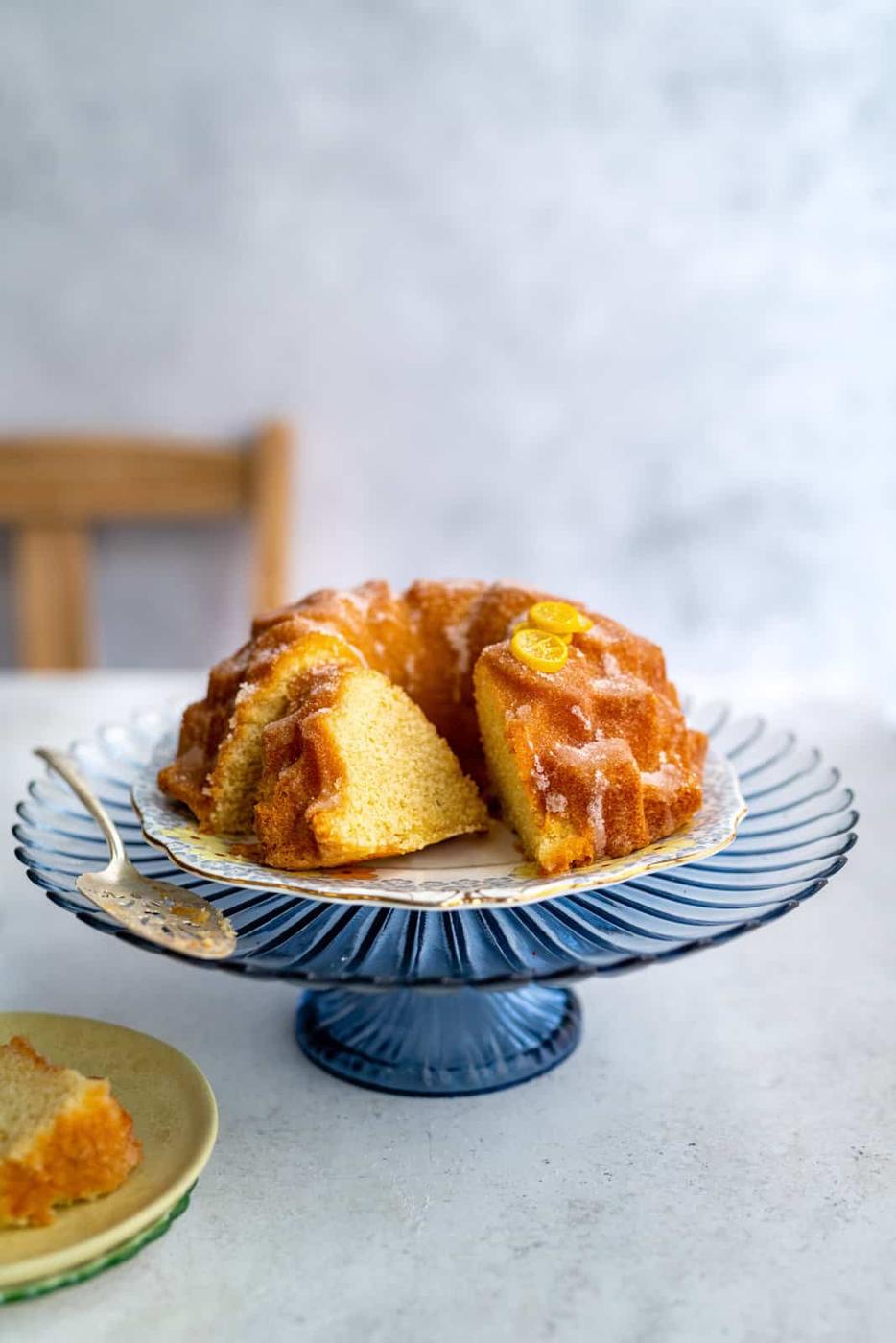 Lemon bundt cake with drizzle on a cake stand