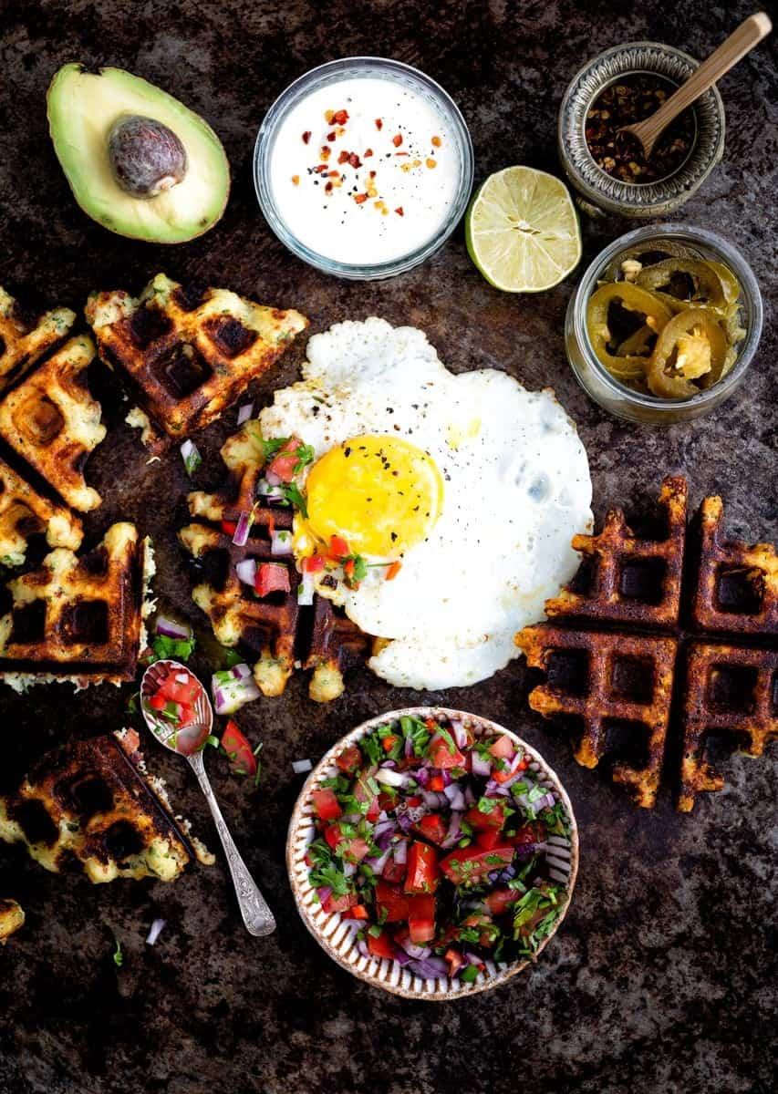 Fully loaded mashed potato waffles with egg, salsa, soured cream and avocado