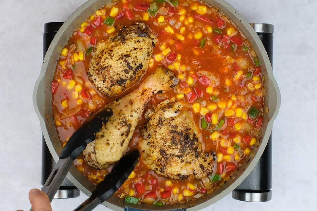 making arroz con pollo in a pan