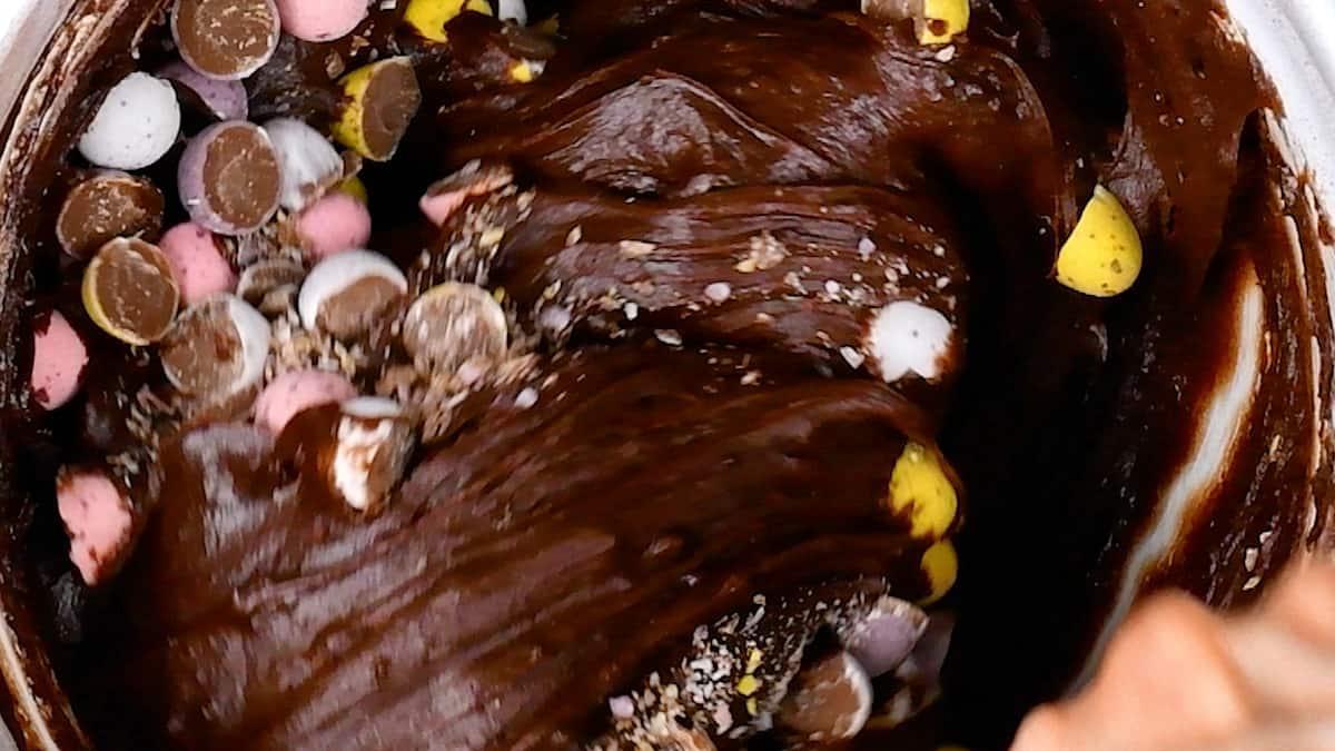 Folding Cadbury's Mini Eggs into brownie batter