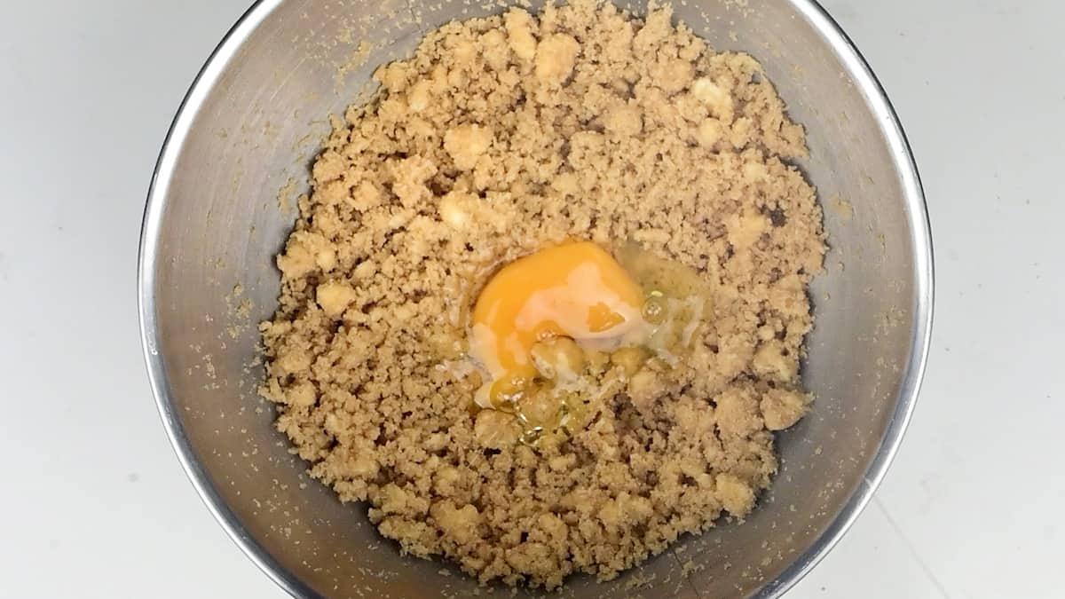 Cookie dough in a large metal mixing bowl