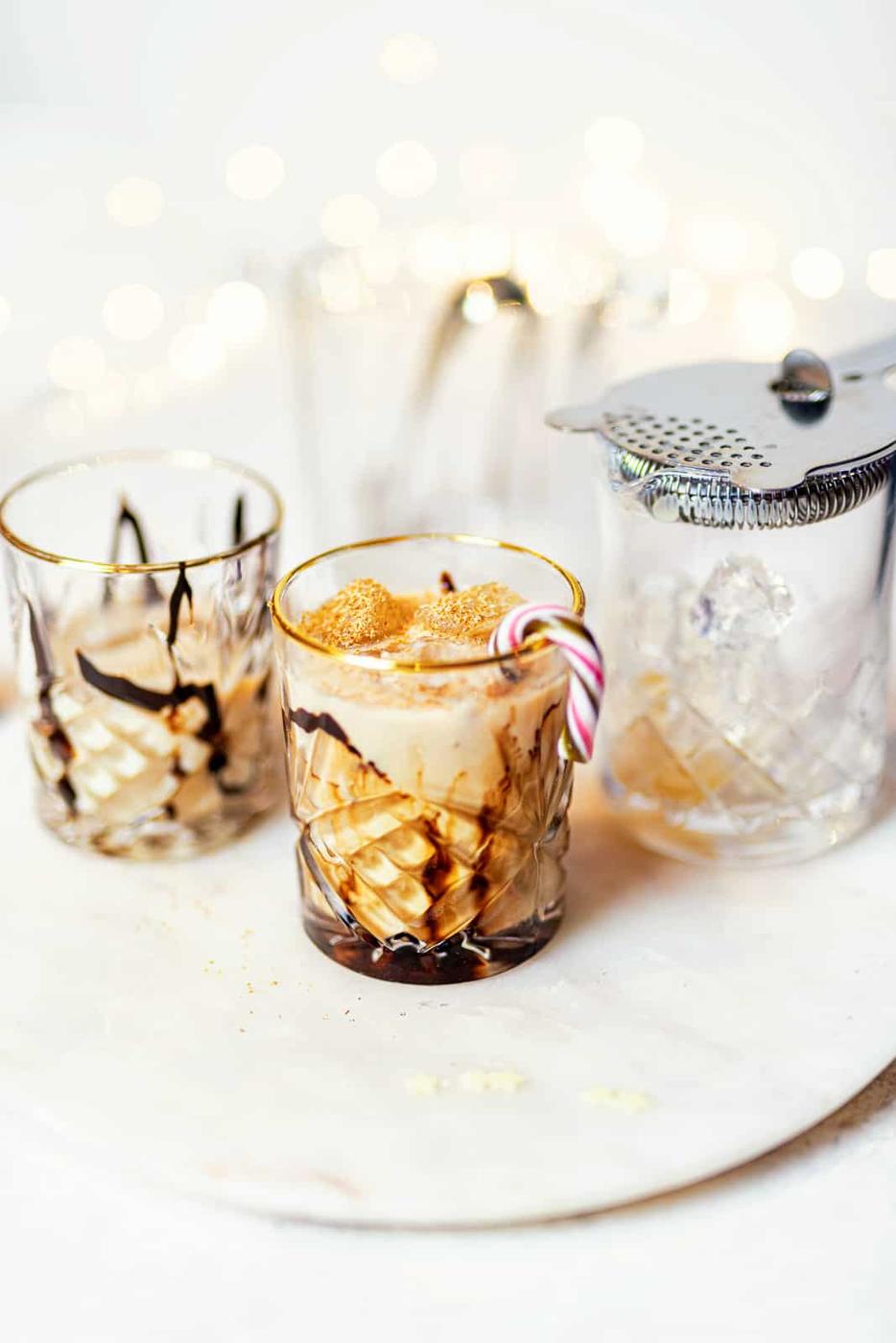 Mudslide drink in a rocks glass with candy cane garnish