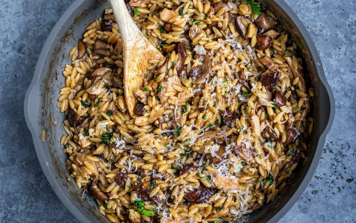 overheat photo of a pan with mushroom orzo (mushroom orzotto)