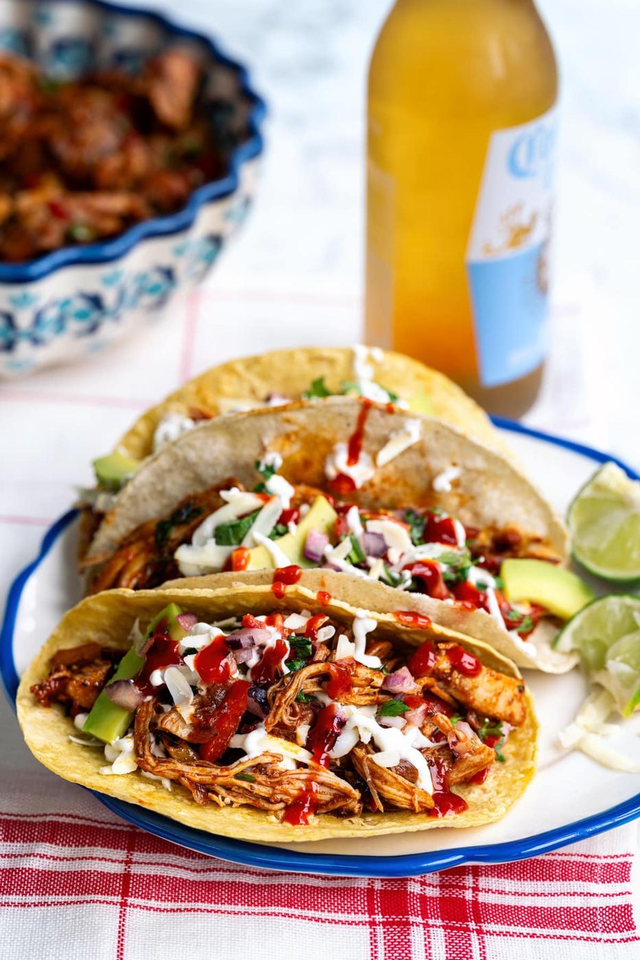 Chicken tacos with pico de gallo sour cream on a blue plate