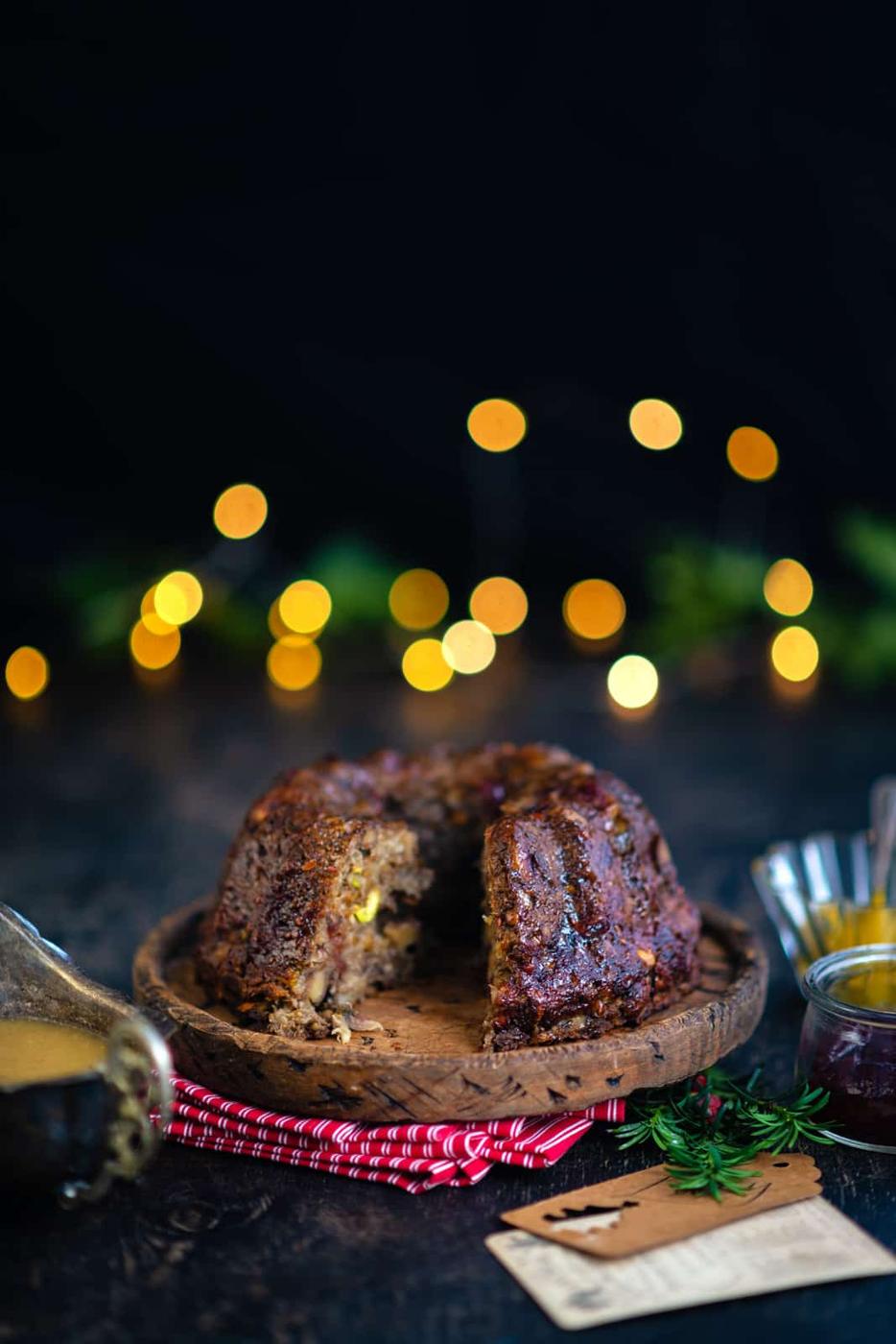Nut roast with slice taken out and gravy on the side