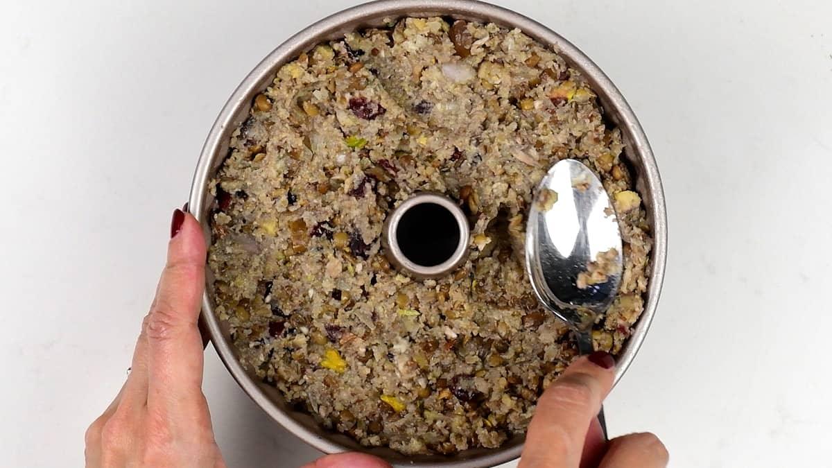 packing nut roast mix in a small bundt tin
