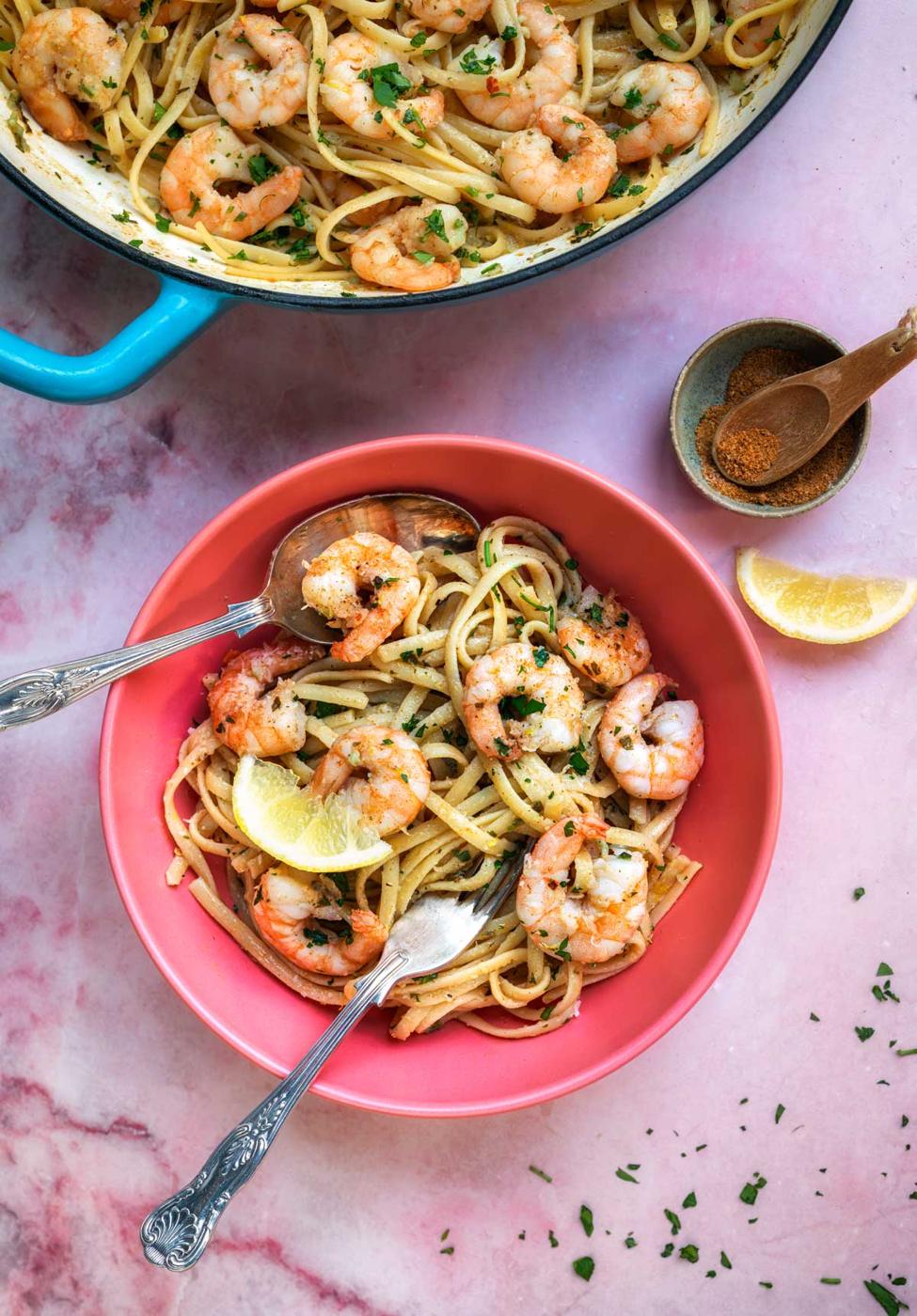 pink bowl with serving of shrimp scampi pasta with Old Bay seasoning