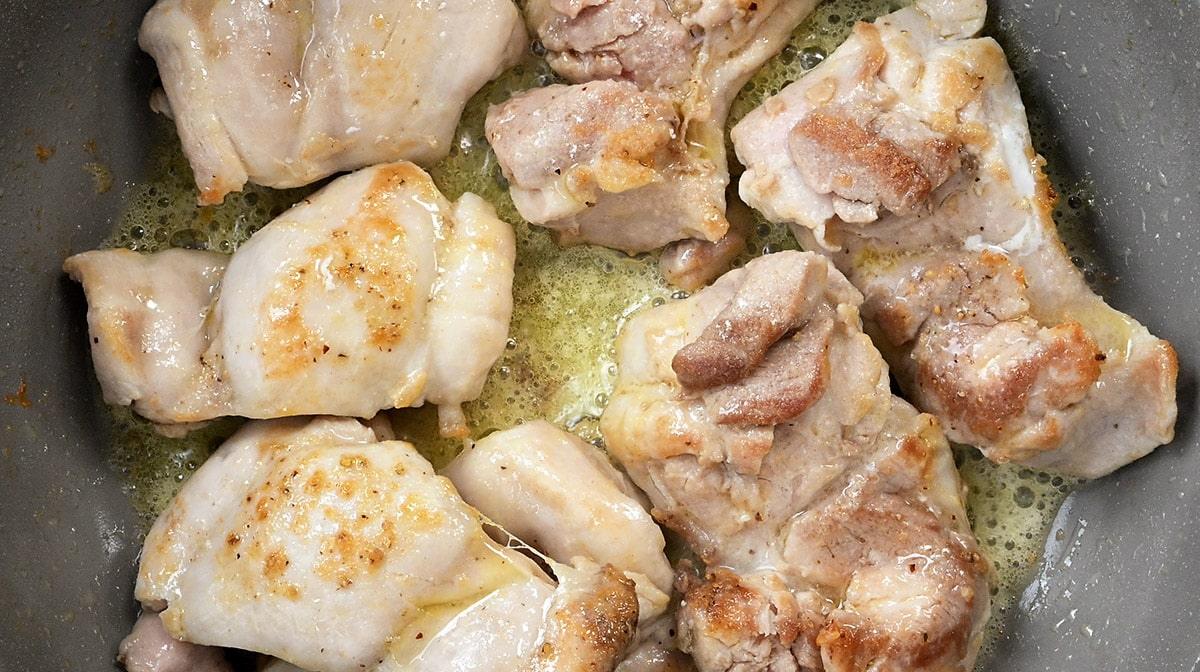 pan searing chicken thighs close up
