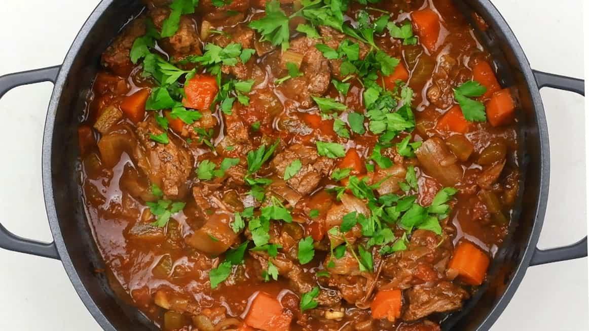 pot of greek beef stew garnished with parsley