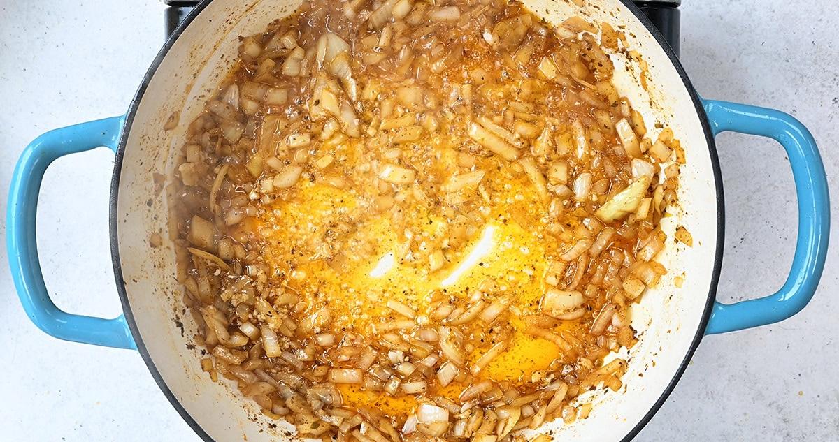 pan frying onion in a skillet