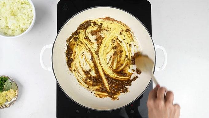 Frying spices for Indian curry in a large casserole