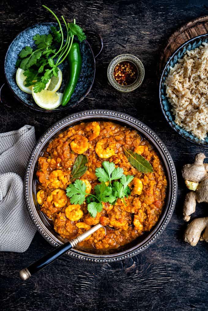 Bowl of Dhansak against a rustic dark background