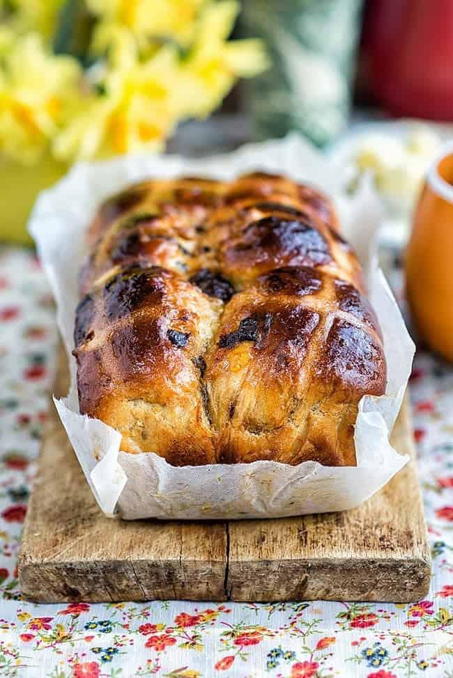 Orange and Chocolate Hot Cross Bun Loaf on a wooden board