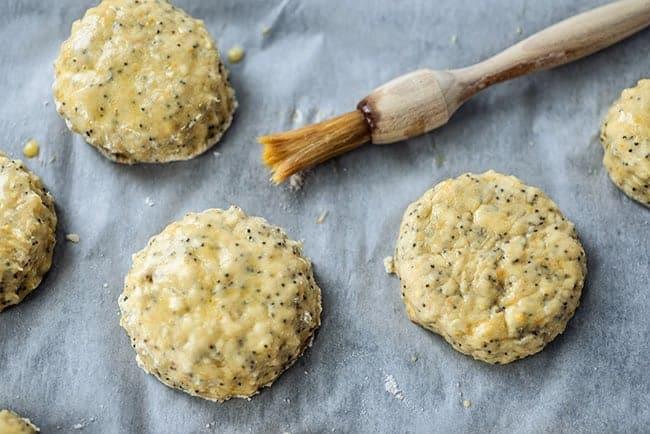 sweet scones on baking tray brushed with egg wash