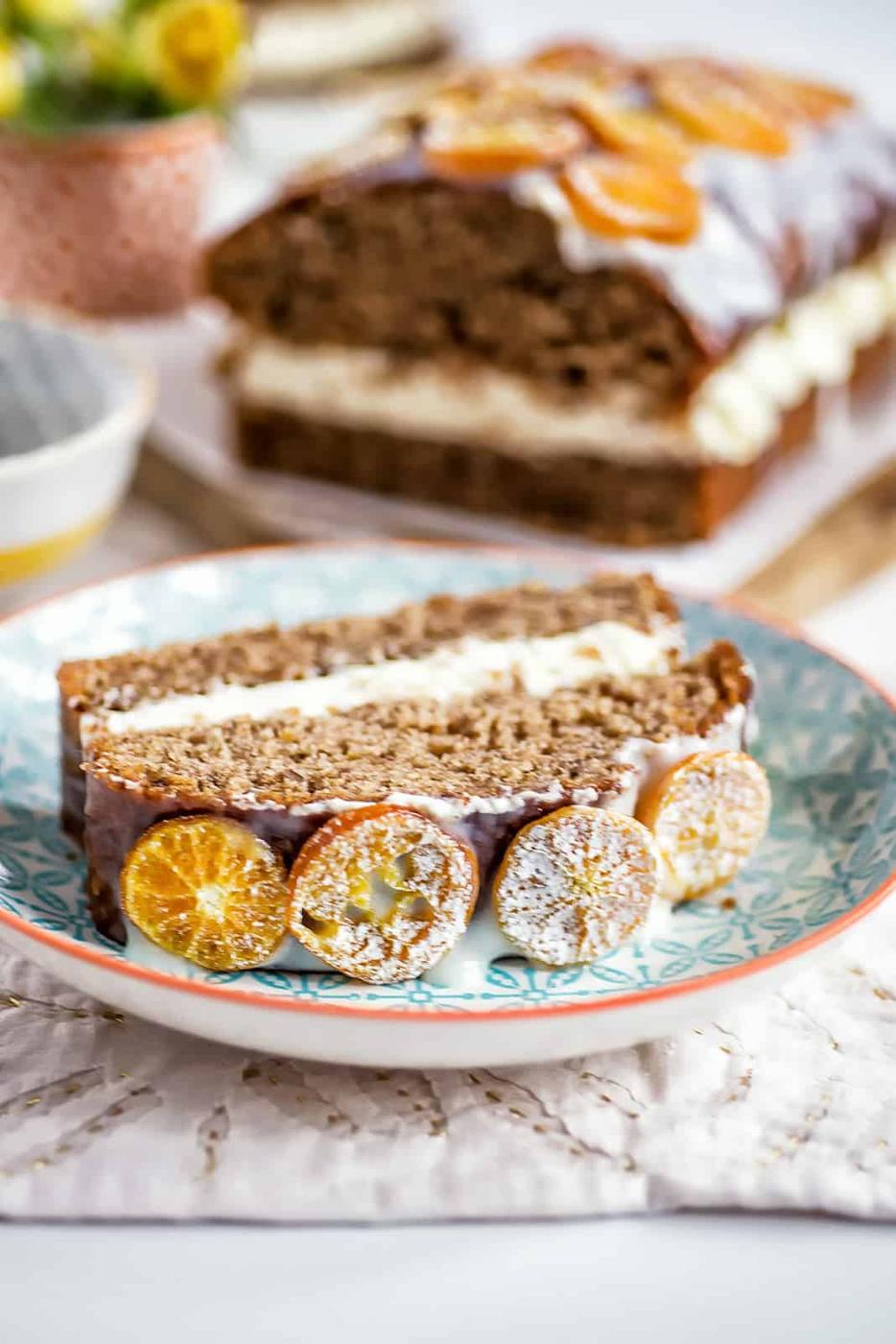 Slice of orange olive oil cake on a patterned plate