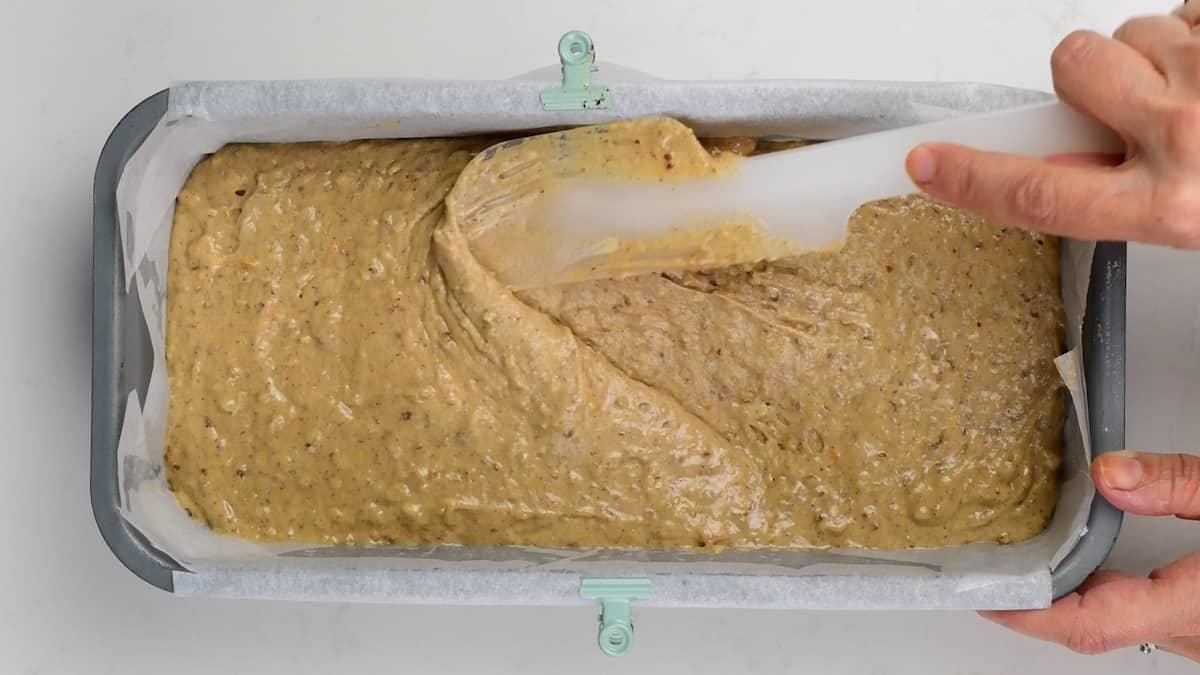 levelling cake batter in a loaf tin