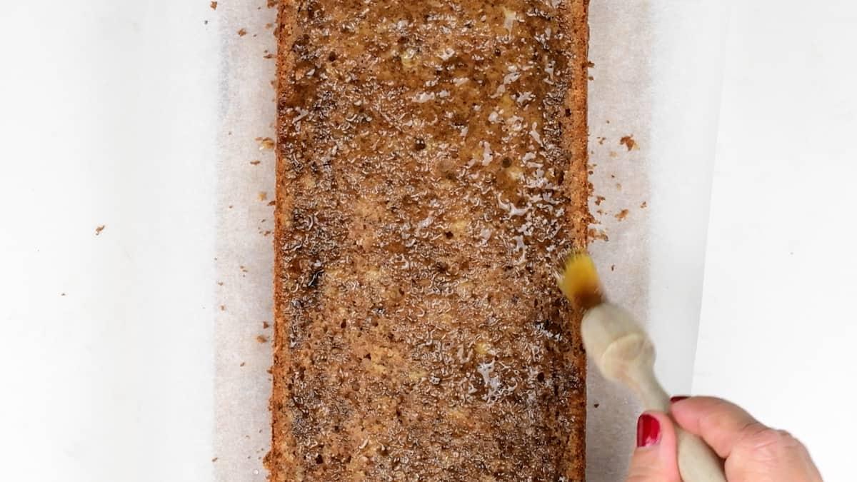 Brushing orange loaf cake with syrup