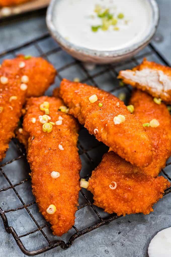Oven-baked Buffalo chicken fingers with feta yoghurt dip