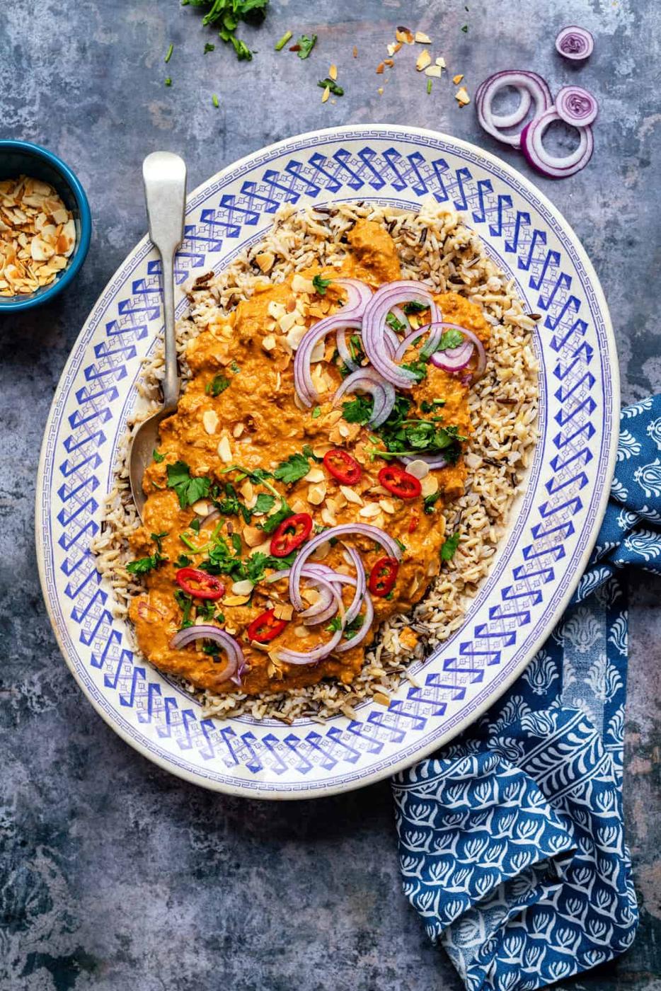 Platter of lamb pasanda curry served over a bed of rice