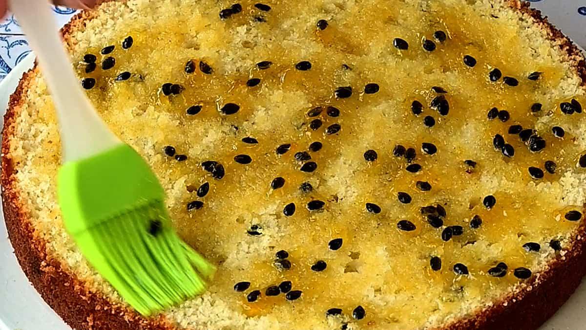 brushing cake with passion fruit syrup
