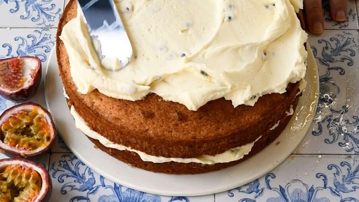 covering cake with frosting