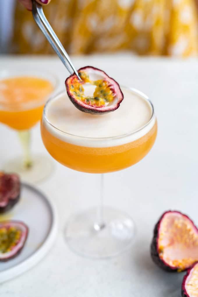 Adding slice of passion fruit to porn star martini